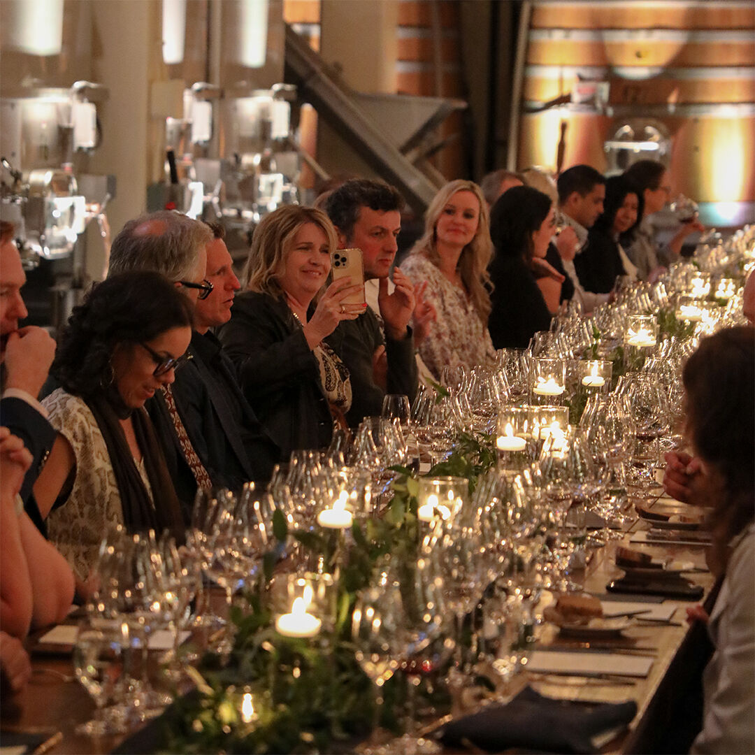 Candlit table of people at La Crête Celebration.