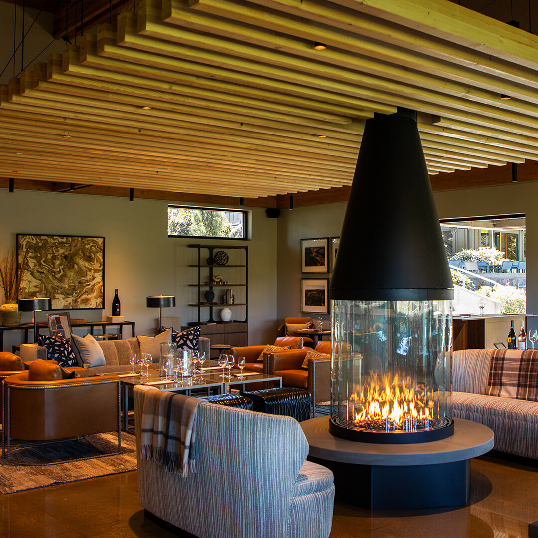 Full view of the remodeled WillaKenzie tasting room with fireplace on.